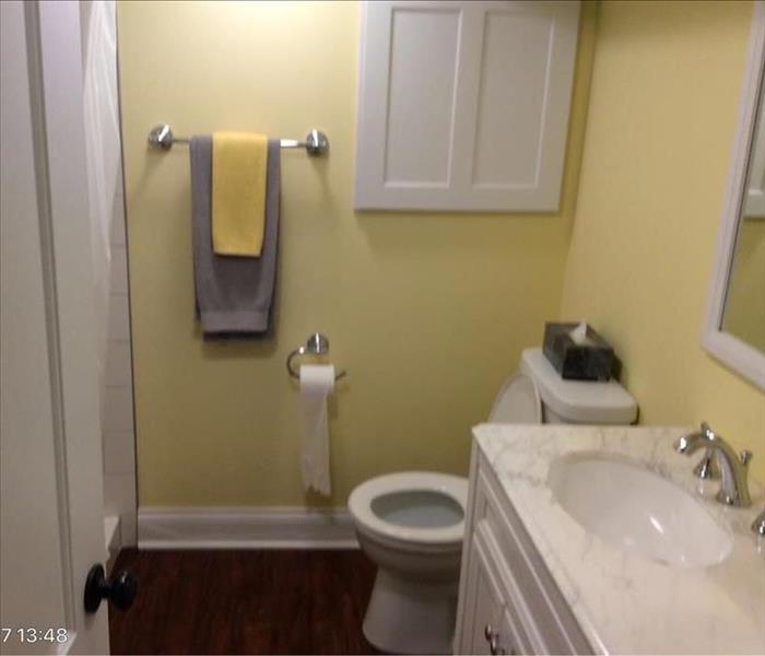 Clean yellow painted bathroom