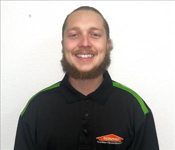 man with a beard smiling in a servpro polo