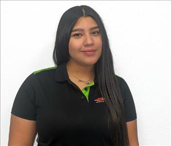 woman with long dark hair in a servpro polo