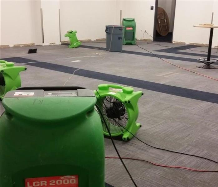 Large room with Green Fans drying out floors