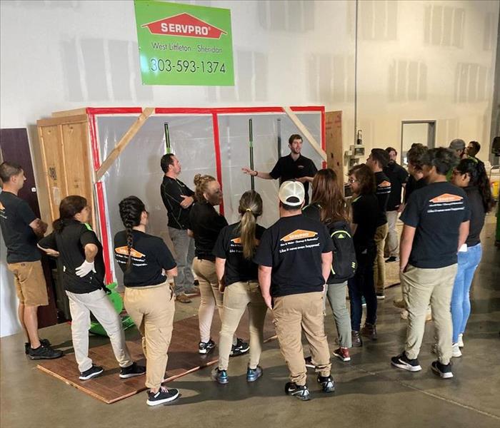 SERVPRO employees standing listening to instruction
