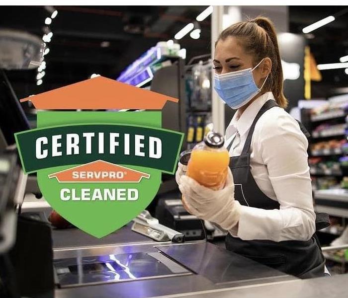 grocery store employee with Certified SERVPRO clean logo