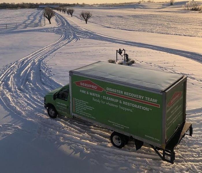 Green Servpro truck on snow covered road